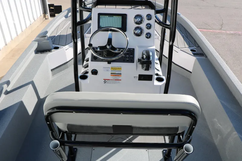 Slide: The Image of 2025 Vexus ACX 2210 boat interior with steering console and seating. - 27