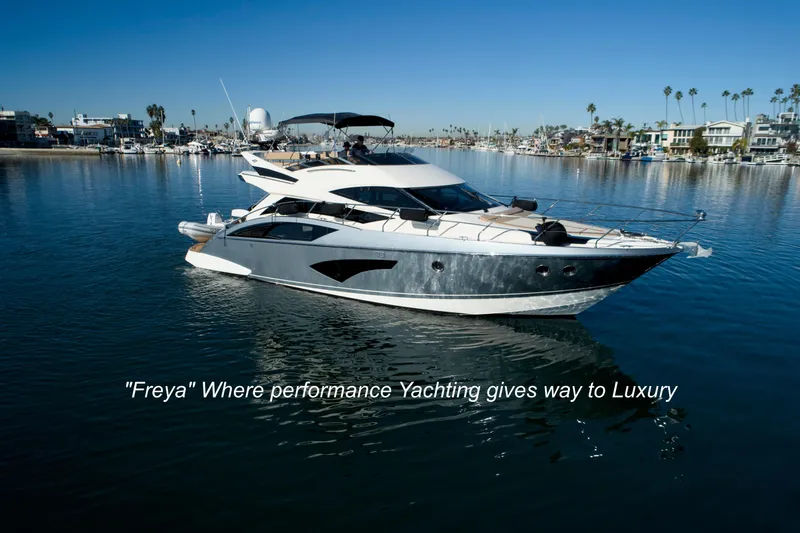 The Image of Luxurious 2013 Marquis 500 Sport Bridge yacht, "Freya," cruising in a serene marina. - 0