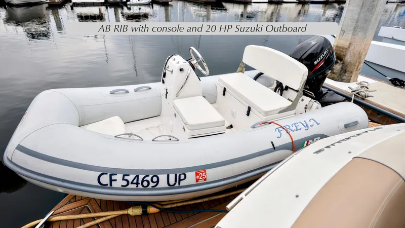 Slide: The Image of AB RIB with console and 20 HP Suzuki outboard, docked near Marquis 500 Sport Bridge. - 18
