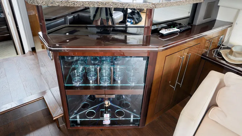 Slide: The Image of Luxurious interior of 2013 Marquis 500 Sport Bridge yacht with glass cabinet and modern decor. - 22