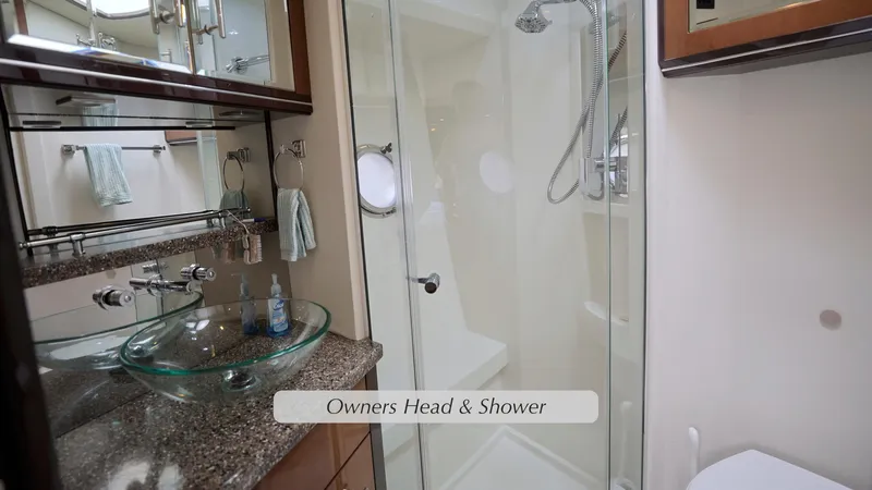 Slide: The Image of Luxurious bathroom in 2013 Marquis 500 Sport Bridge yacht with glass sink and shower. - 33