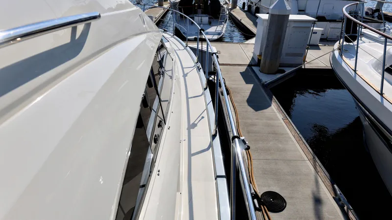 Slide: The Image of 2013 Marquis 500 Sport Bridge yacht docked at marina. - 5