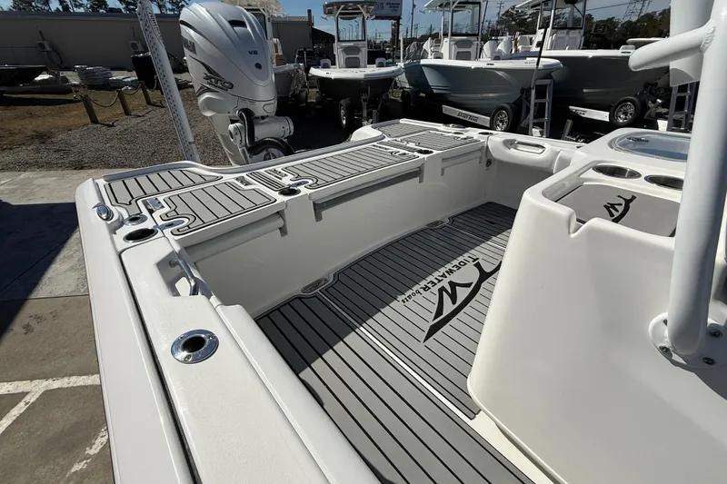 Slide: The Image of 2019 Tidewater 2700 Carolina Bay boat interior with sleek deck design and powerful outboard engine. - 10