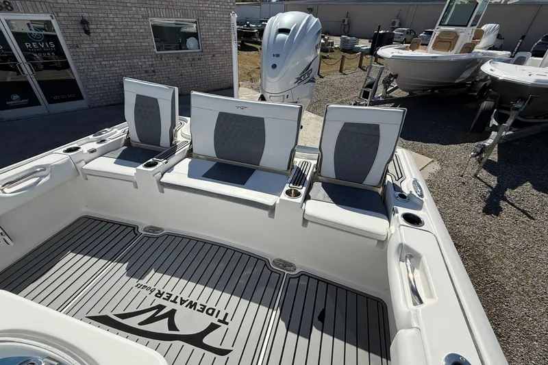 Slide: The Image of 2019 Tidewater 2700 Carolina Bay boat interior with seating and Yamaha engine. - 12