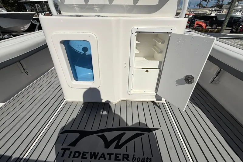 Slide: The Image of 2019 Tidewater 2700 Carolina Bay boat interior with storage compartment and logo on deck. - 18
