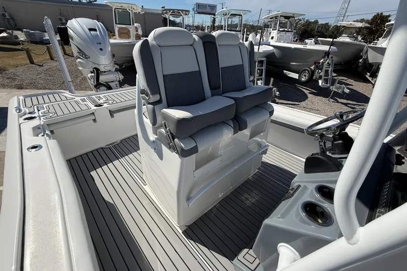 Slide: The Image of 2019 Tidewater 2700 Carolina Bay boat interior with dual seats and steering console. - 20