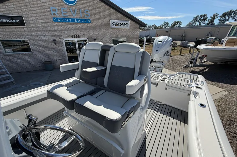 Slide: The Image of 2019 Tidewater 2700 Carolina Bay boat at Revis Yacht Sales, featuring dual seats and steering wheel. - 22