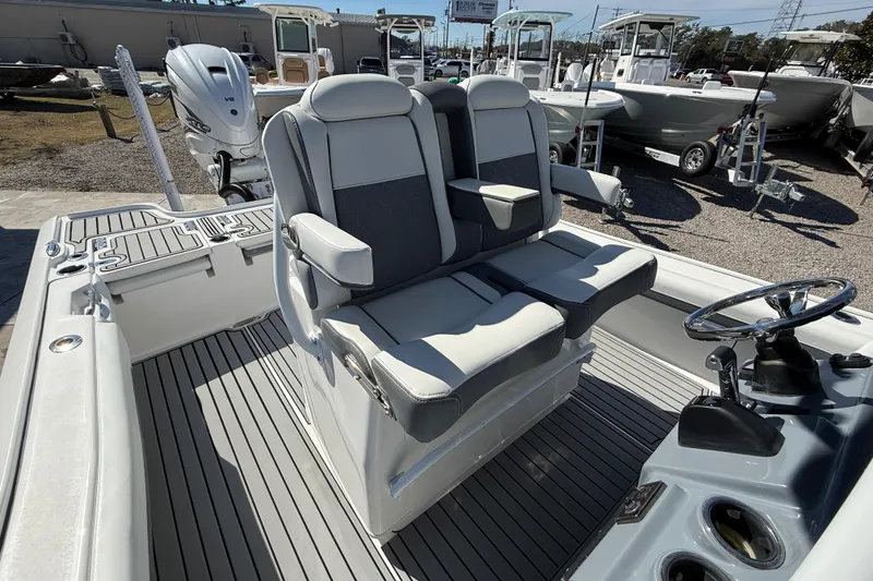 Slide: The Image of 2019 Tidewater 2700 Carolina Bay boat interior with dual seats and steering wheel. - 23