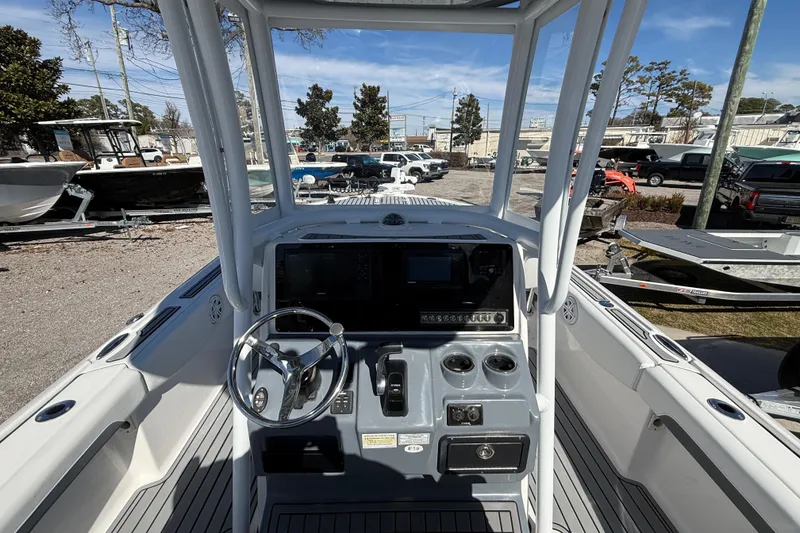 Slide: The Image of 2019 Tidewater 2700 Carolina Bay boat console with steering wheel and controls. - 24