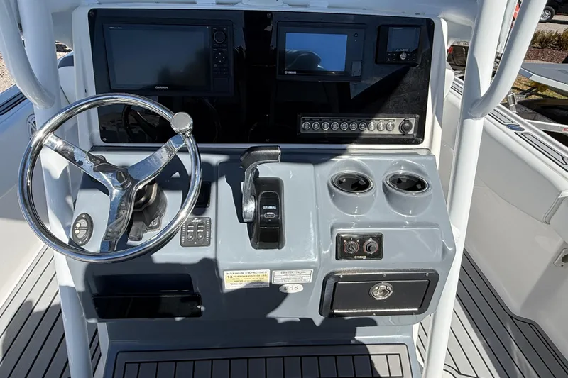Slide: The Image of 2019 Tidewater 2700 Carolina Bay boat console with steering wheel and controls. - 25
