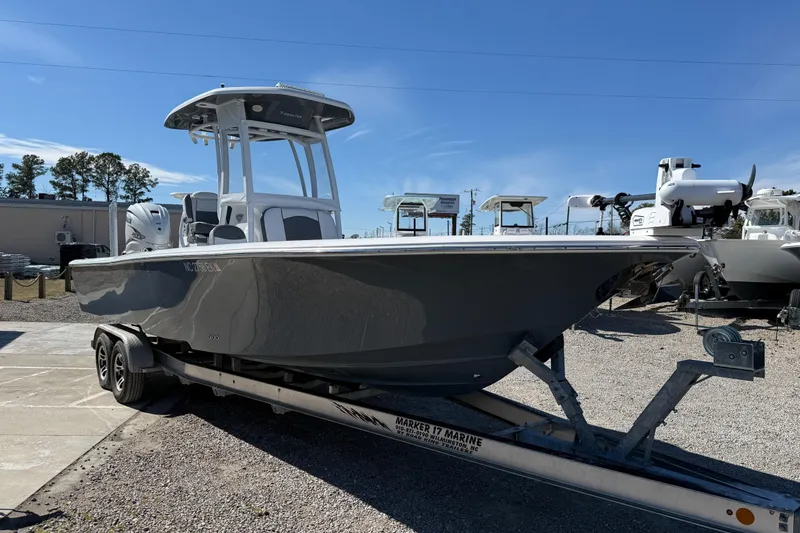 Slide: The Image of 2019 Tidewater 2700 Carolina Bay boat on trailer under clear blue sky. - 3