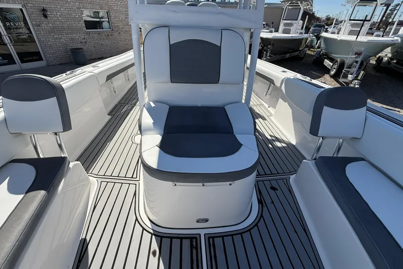Slide: The Image of 2019 Tidewater 2700 Carolina Bay boat interior with seating and deck view. - 31