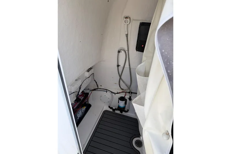 Slide: The Image of Interior of 2019 Tidewater 2700 Carolina Bay boat, featuring shower and equipment. - 35