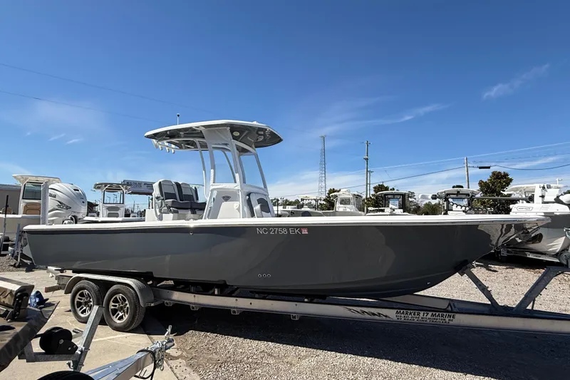 Slide: The Image of 2019 Tidewater 2700 Carolina Bay boat on trailer under clear blue sky. - 4