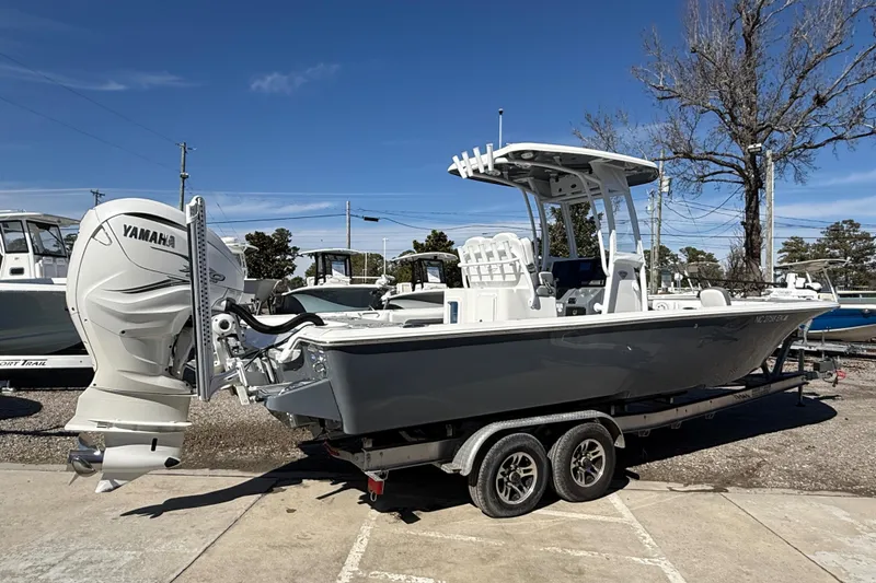 Slide: The Image of 2019 Tidewater 2700 Carolina Bay boat with Yamaha engine on trailer, parked outdoors. - 5