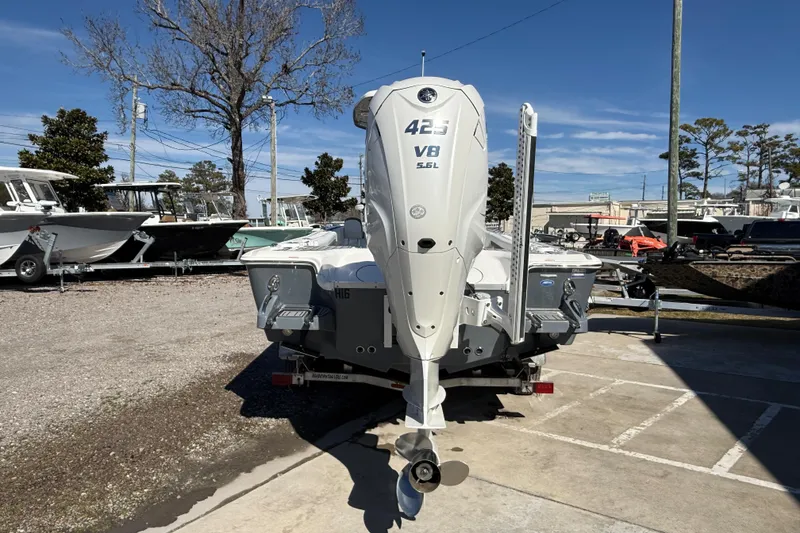 Slide: The Image of 2019 Tidewater 2700 Carolina Bay boat with powerful V8 engine, parked outdoors. - 6