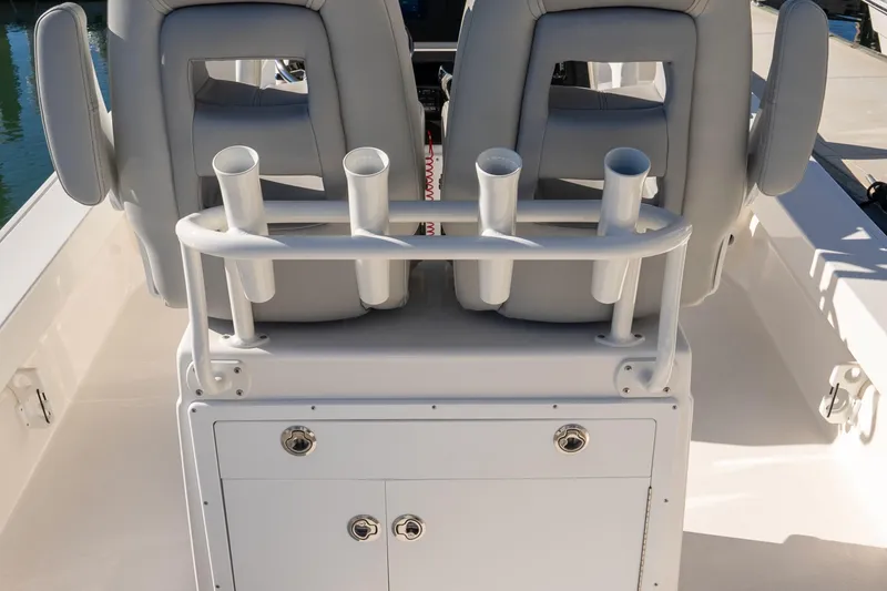 Slide: The Image of 2026 Bay Rider 239 Bay boat interior with rod holders and cushioned seats. - 16