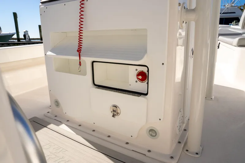 Slide: The Image of 2026 Bay Rider 239 Bay boat interior with storage compartments and control panel. - 19