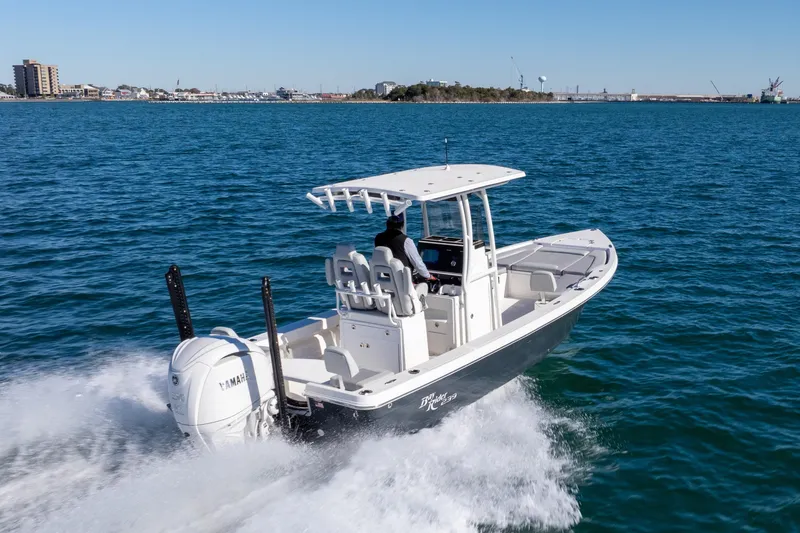 Slide: The Image of 2026 Bay Rider 239 Bay boat cruising on open water, showcasing sleek design and powerful engine. - 2