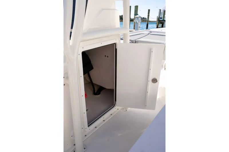 Slide: The Image of Open storage compartment on 2026 Bay Rider 239 Bay boat, dockside view. - 21