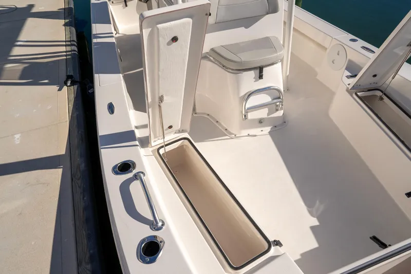 Slide: The Image of 2026 Bay Rider 239 Bay boat interior with open storage compartments and seating. - 28
