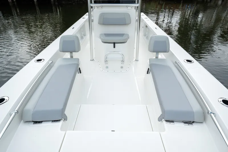 Slide: The Image of 2026 Bay Rider 2260 FS Skiff interior with gray seating, spacious deck, and water backdrop. - 11