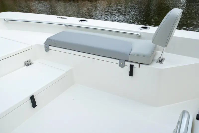 Slide: The Image of Bay Rider 2260 FS Skiff 2026 boat interior with gray seating and storage compartments. - 13