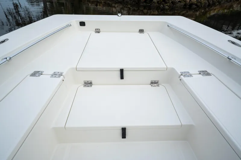 Slide: The Image of 2026 Bay Rider 2260 FS Skiff boat deck with storage compartments. - 16