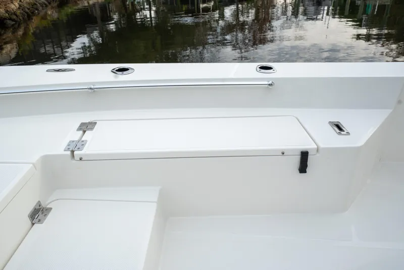 Slide: The Image of 2026 Bay Rider 2260 FS Skiff interior detail with storage compartment by the water. - 17