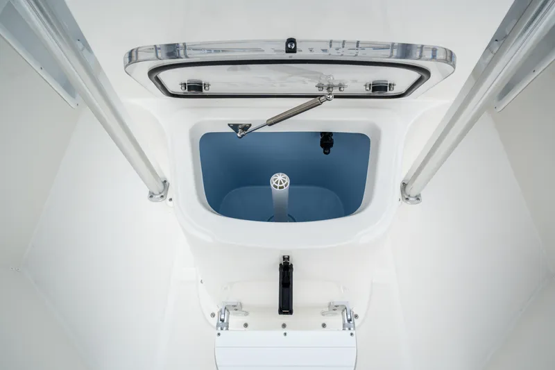 Slide: The Image of 2026 Bay Rider 2260 FS Skiff livewell interior with open hatch and hydraulic support. - 21