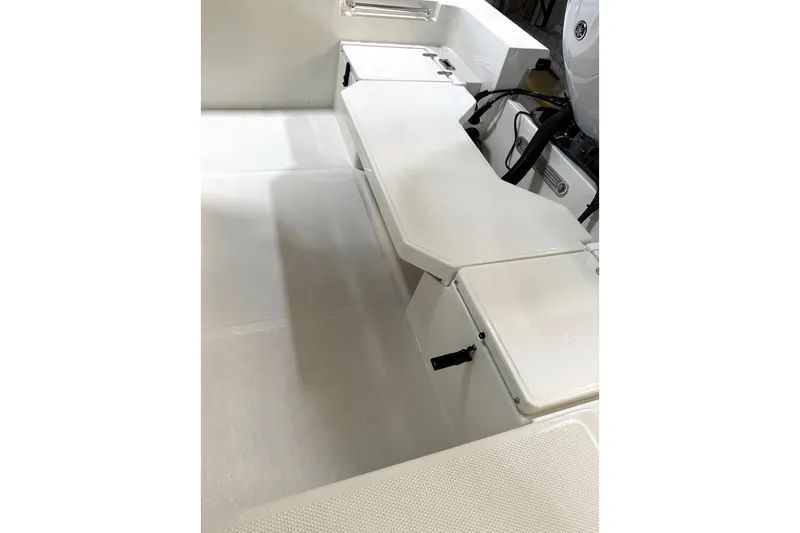Slide: The Image of 2026 Bay Rider 2260 FS Skiff interior with white seating and storage compartments. - 28