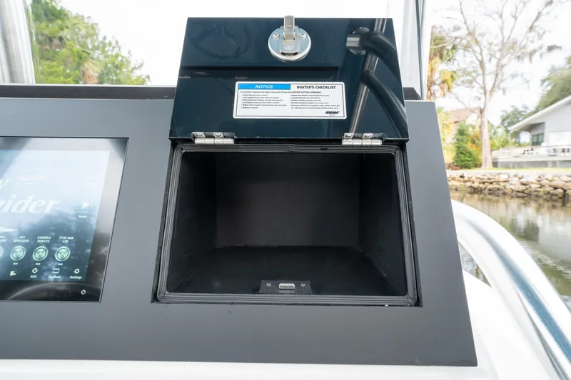 Slide: The Image of 2026 Bay Rider 2260 FS Skiff console with open storage compartment and touchscreen display. - 9