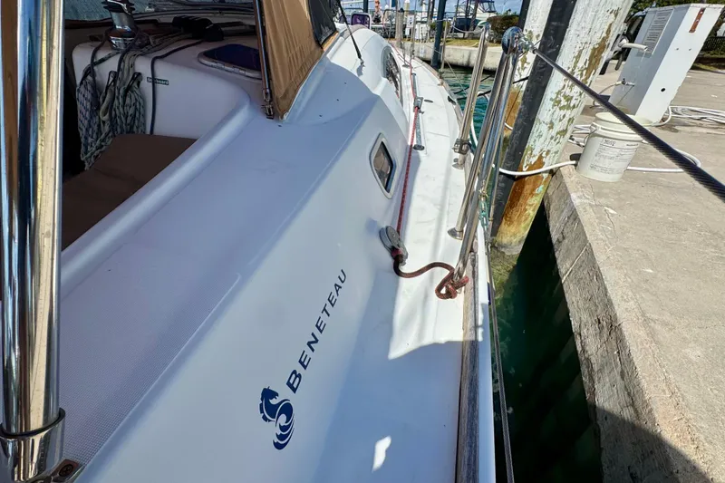 Slide: The Image of 2008 Beneteau Oceanis 40 yacht docked, showcasing sleek deck design and branding. - 12