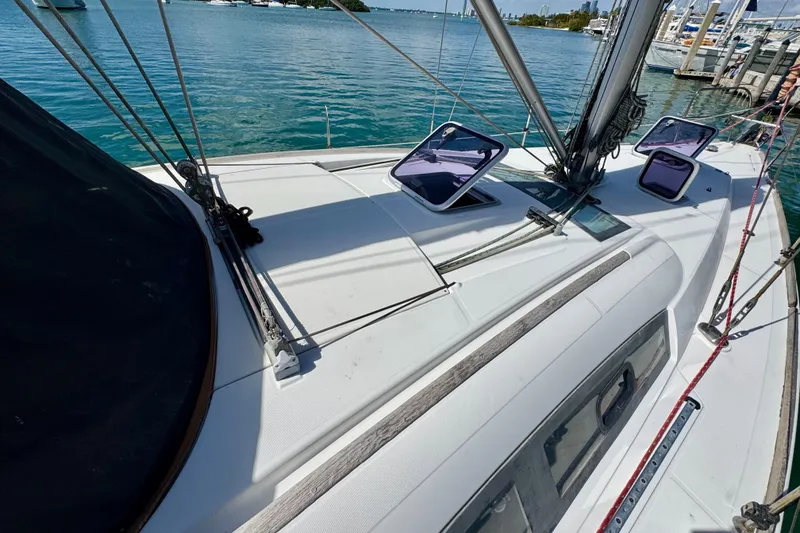 Slide: The Image of 2008 Beneteau Oceanis 40 sailboat deck with open hatches, docked in a marina. - 13