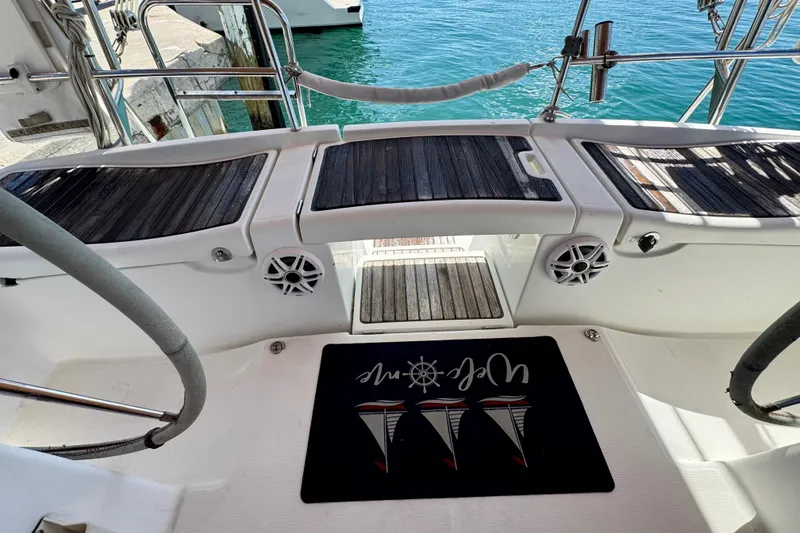 Slide: The Image of Cockpit of 2008 Beneteau Oceanis 40 sailboat with nautical-themed mat and teak flooring. - 14