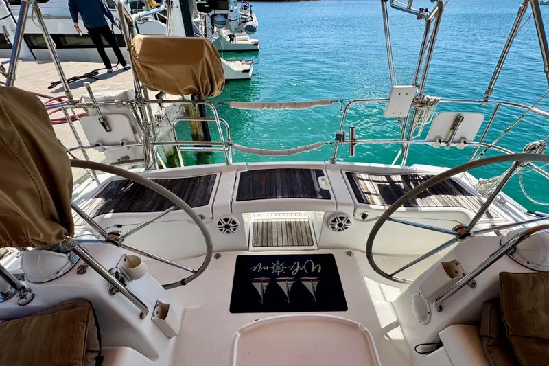 Slide: The Image of Cockpit view of a 2008 Beneteau Oceanis 40 sailboat docked by turquoise water. - 17