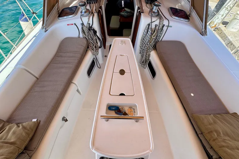 Slide: The Image of Cockpit of 2008 Beneteau Oceanis 40 sailboat with cushioned seating and nautical equipment. - 18