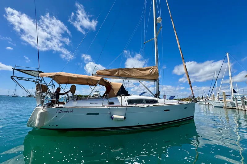 Slide: The Image of 2008 Beneteau Oceanis 40 sailboat docked in a sunny marina. - 2