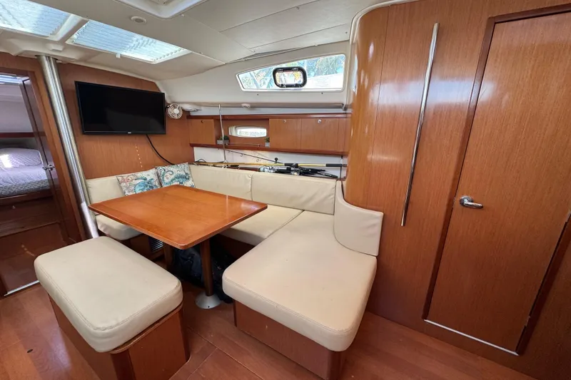 Slide: The Image of Interior of 2008 Beneteau Oceanis 40 yacht with cozy seating and wooden finishes. - 24