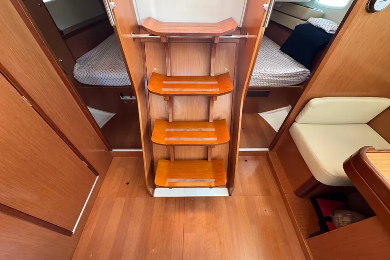 Slide: The Image of Interior of 2008 Beneteau Oceanis 40 sailboat with wooden steps and cozy cabin layout. - 26