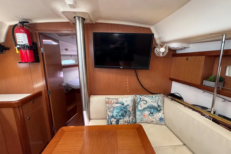 Slide: The Image of Interior of 2008 Beneteau Oceanis 40 yacht with cozy seating, TV, and nautical decor. - 39