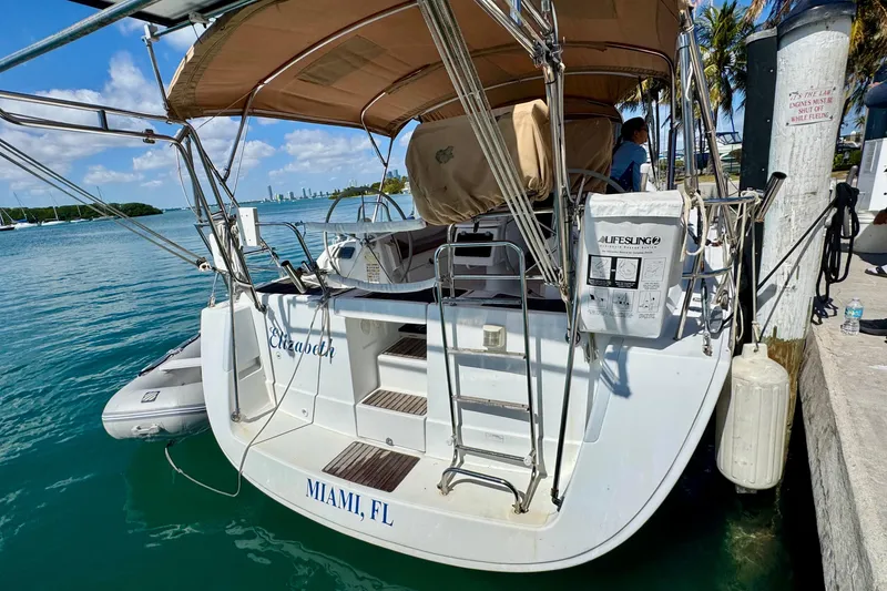 Slide: The Image of 2008 Beneteau Oceanis 40 docked in Miami, Florida, with lifebuoy and dinghy. - 4