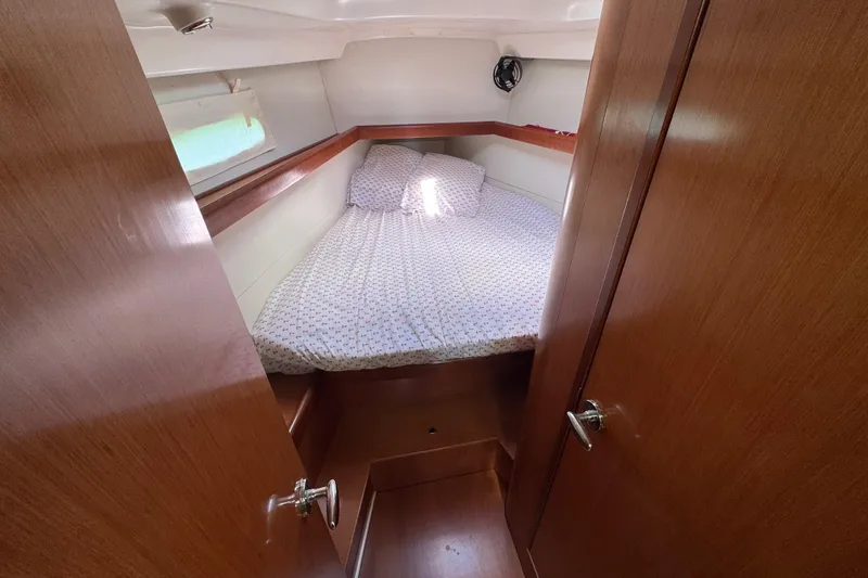 Slide: The Image of Cozy cabin interior of 2008 Beneteau Oceanis 40 sailboat with wooden finish and bed. - 40