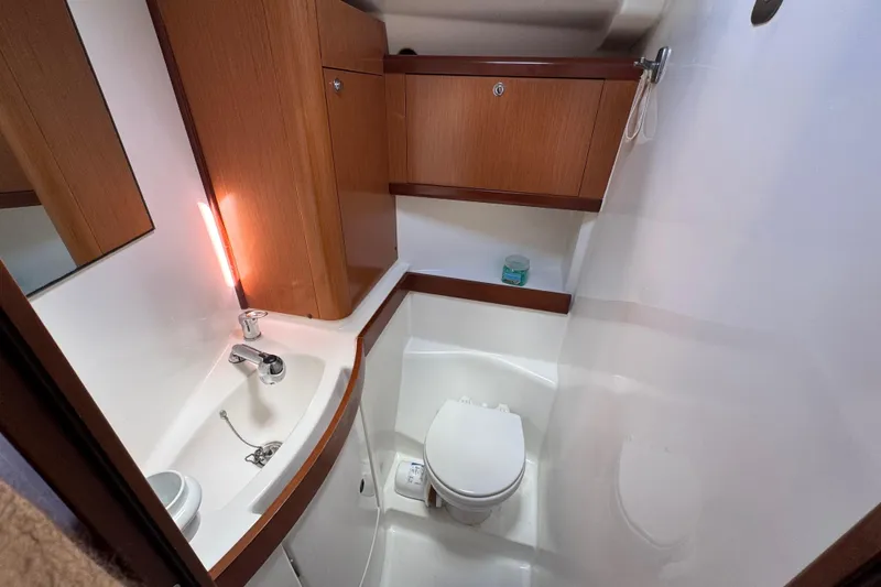 Slide: The Image of 2008 Beneteau Oceanis 40 yacht bathroom with wooden cabinets and modern fixtures. - 41