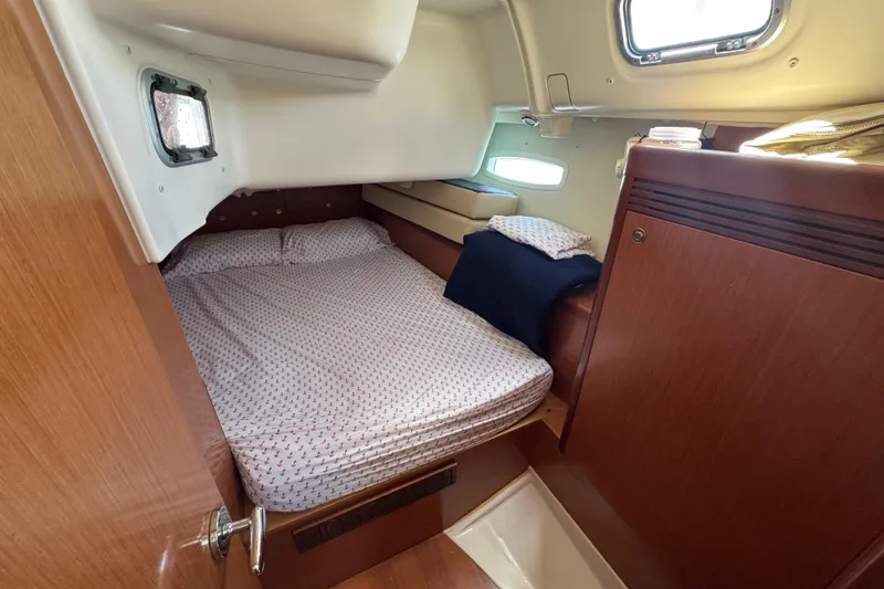 Slide: The Image of Cozy cabin interior of 2008 Beneteau Oceanis 40 sailboat with bed and porthole. - 42