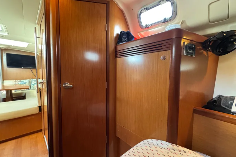 Slide: The Image of Interior of 2008 Beneteau Oceanis 40 yacht, featuring wooden cabinetry and seating area. - 45