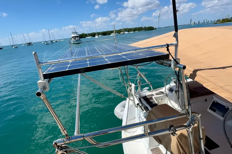 Slide: The Image of 2008 Beneteau Oceanis 40 sailboat with solar panels on deck, anchored in a marina. - 5