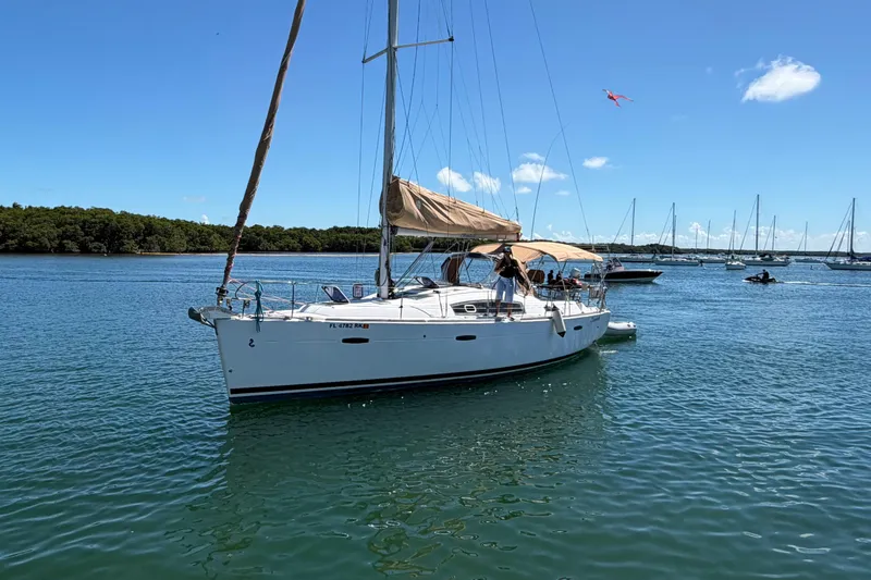 Slide: The Image of 2008 Beneteau Oceanis 40 sailboat on calm water, clear sky, and distant boats. - 51