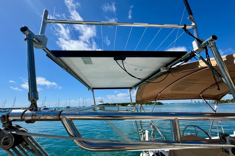 Slide: The Image of Beneteau Oceanis 40 sailboat, 2008 model, featuring solar panel installation under clear blue sky. - 6