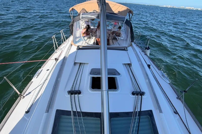 Slide: The Image of 2008 Beneteau Oceanis 40 sailboat on open water, featuring spacious deck and cockpit. - 61